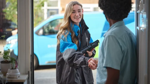 Female British gas Engineer shaking hands with a customer